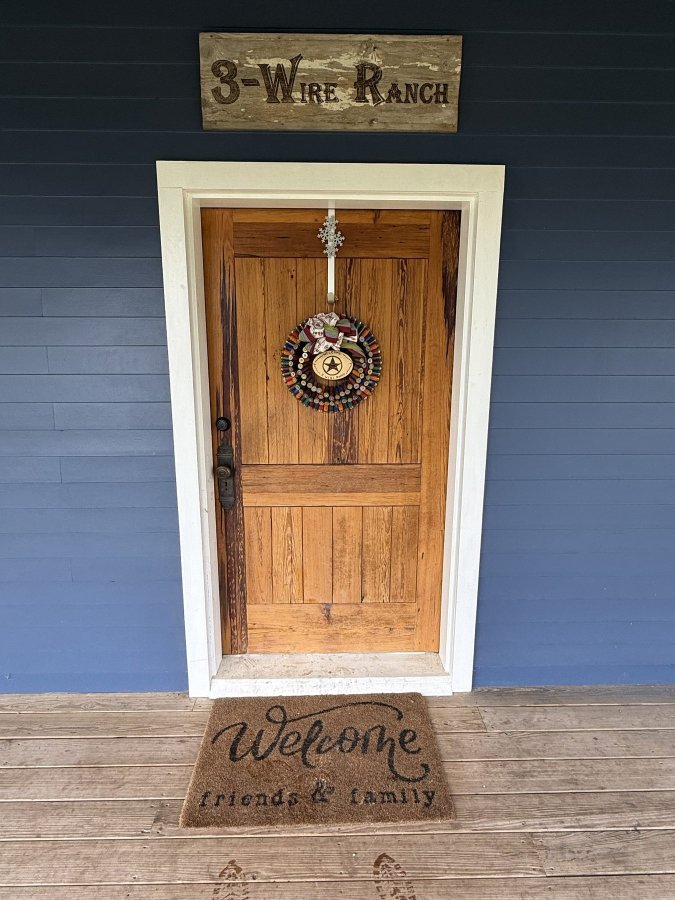 3-Wire Ranch front entrance — handmade sign above a classic ranch door
